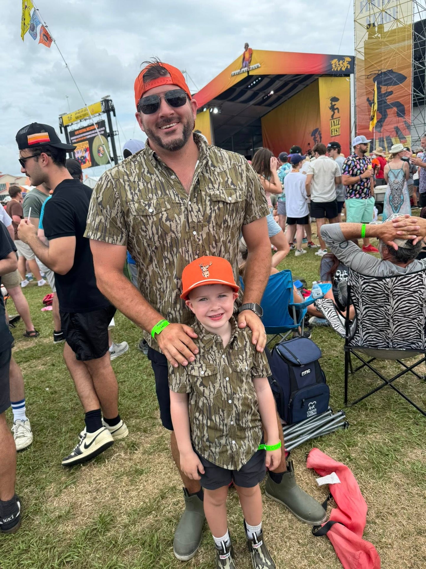 Dad and son wearing Mossy Oak® Bottomland shirts by Velvet Fawn® and Buck Brothers® - matching outdoor family clothing for hunting and southern lifestyle