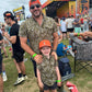 Dad and son wearing Mossy Oak® Bottomland shirts by Velvet Fawn® and Buck Brothers® - matching outdoor family clothing for hunting and southern lifestyle