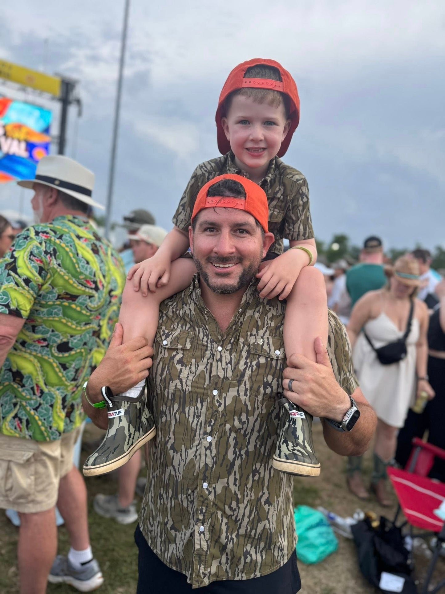 Dad and son wearing Mossy Oak® Bottomland shirts by Velvet Fawn® and Buck Brothers® - matching outdoor family clothing for hunting and southern lifestyle