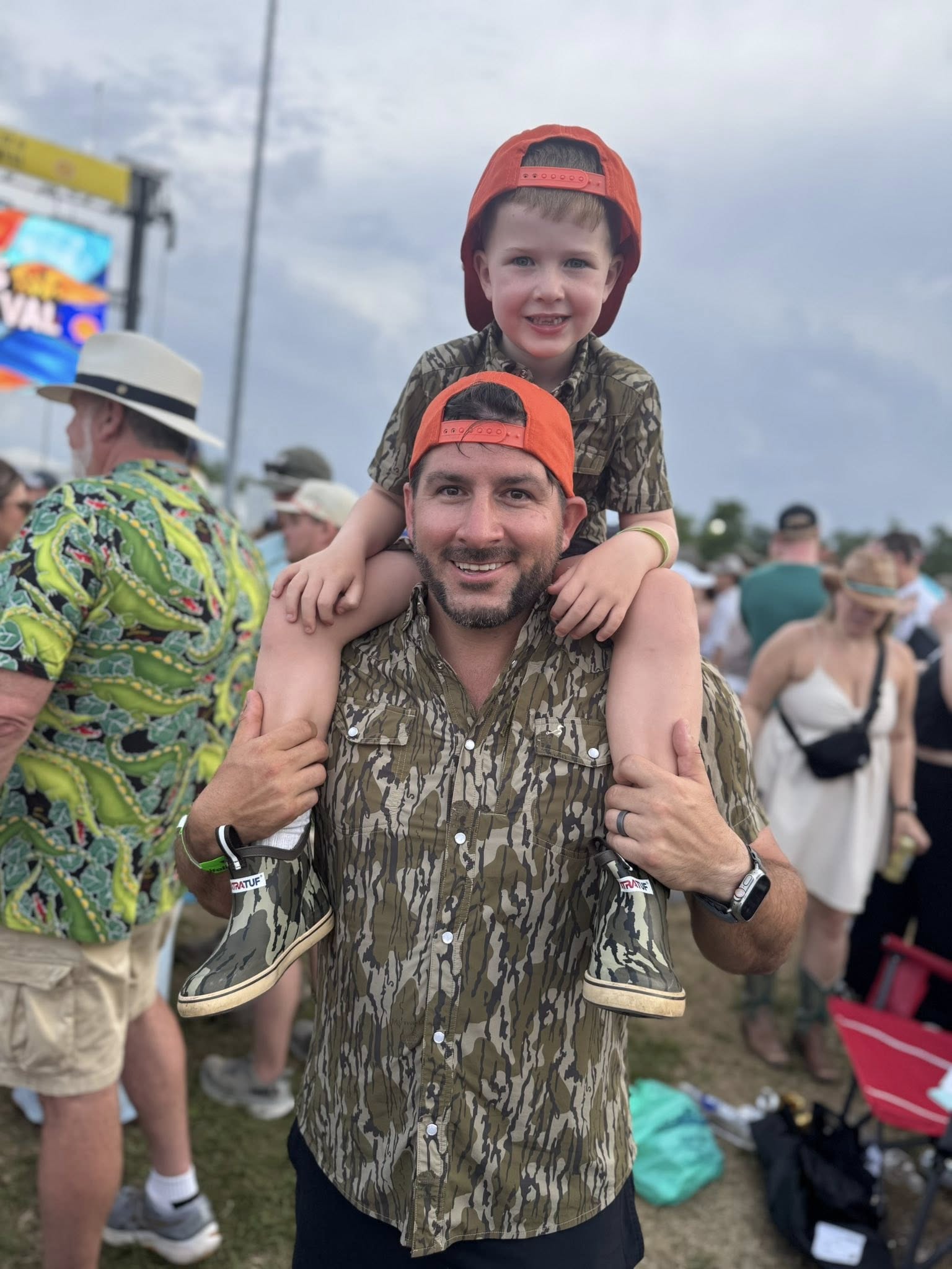 Dad and son wearing Mossy Oak® Bottomland shirts by Velvet Fawn® and Buck Brothers® - matching outdoor family clothing for hunting and southern lifestyle